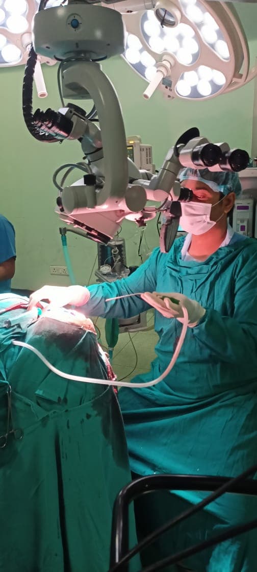Neurosurgeon Dr. Brajesh Kumar Using Surgical Microscope